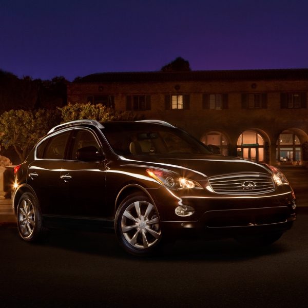 A black 2003 INFINITI EX35 compact SUV parked at night