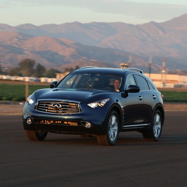A black 2014 INFINITI QX70 crossover driving fast