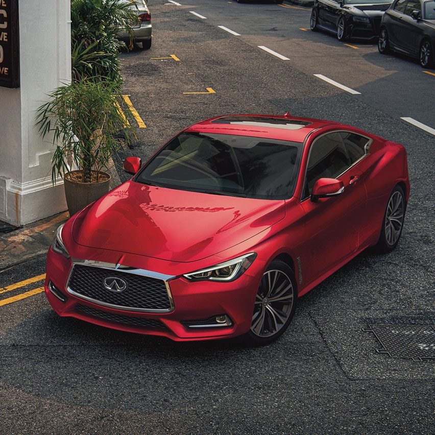 Red INFINITI Q60 parked in city street