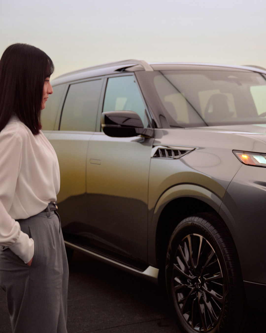 INFINITI Maker Megumi Mitsui examining QX80 exterior