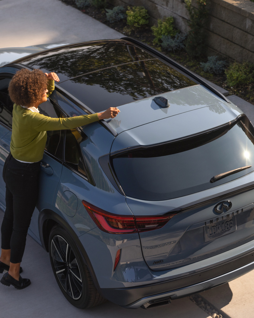INFINITI owner looking over vehicle roof