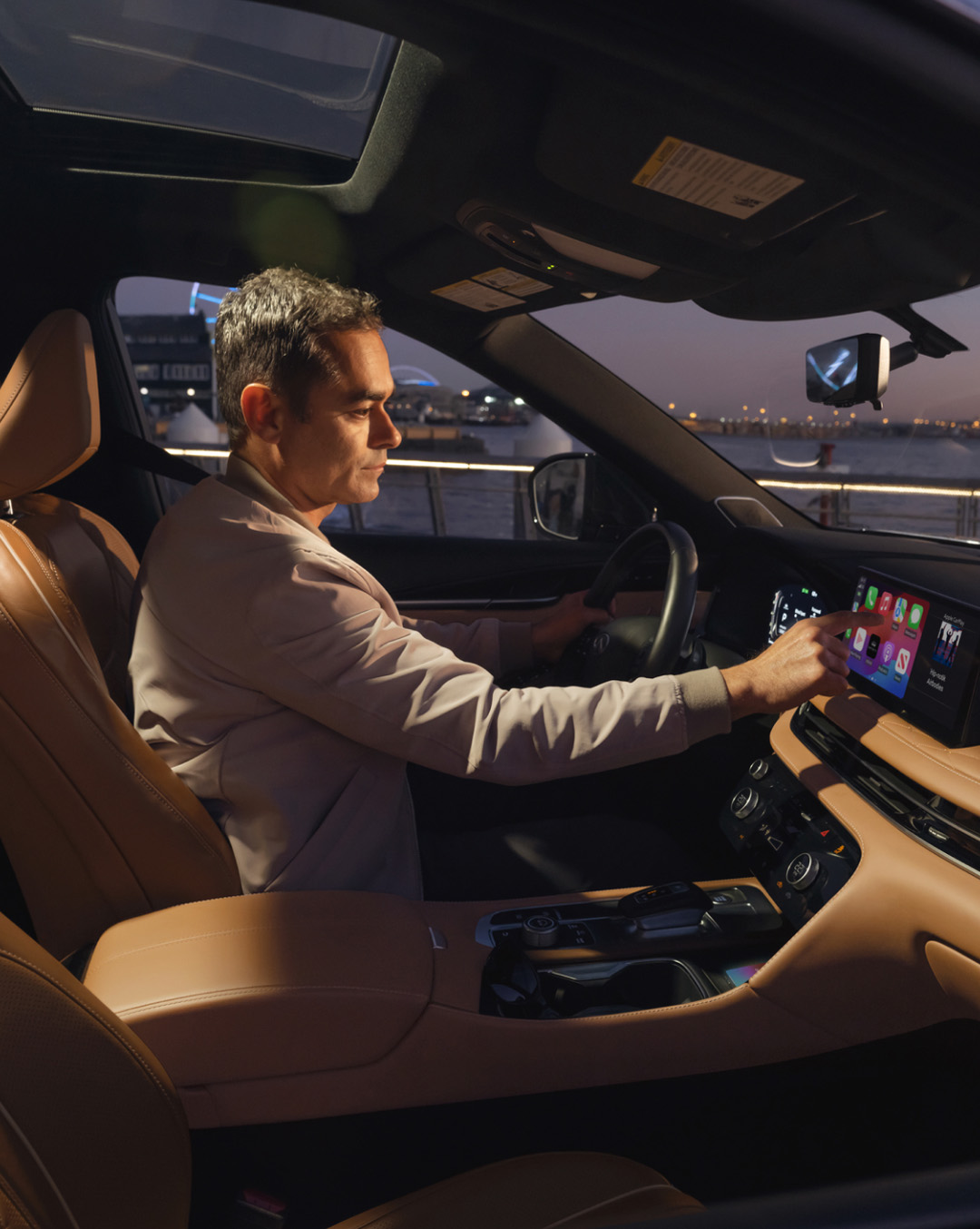 Interior view of owner using INFINITI IQ technologies