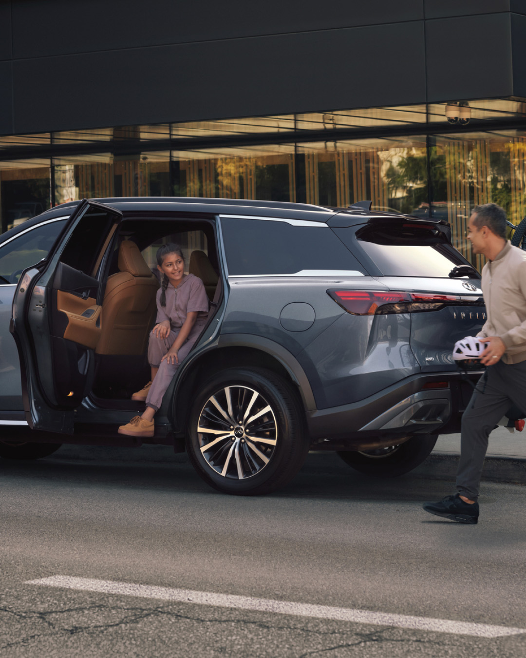 INFINITI owner walking towards girl in passenger seat