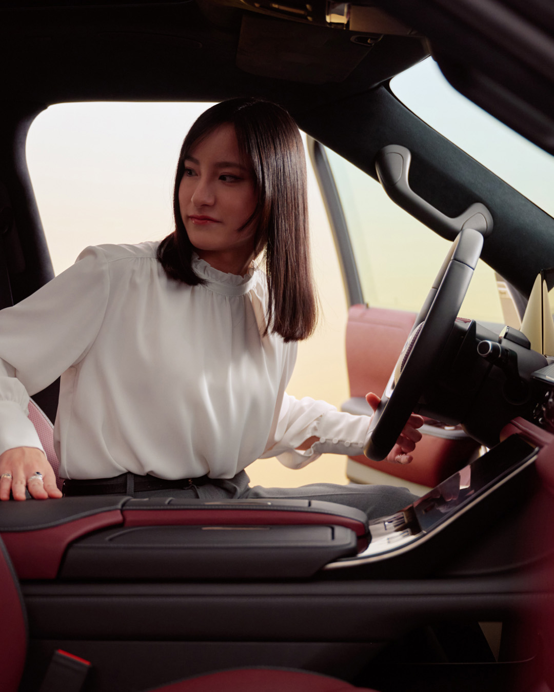 Interior view of INFINITI maker Megumi Mitsui sitting in driver seat of QX80