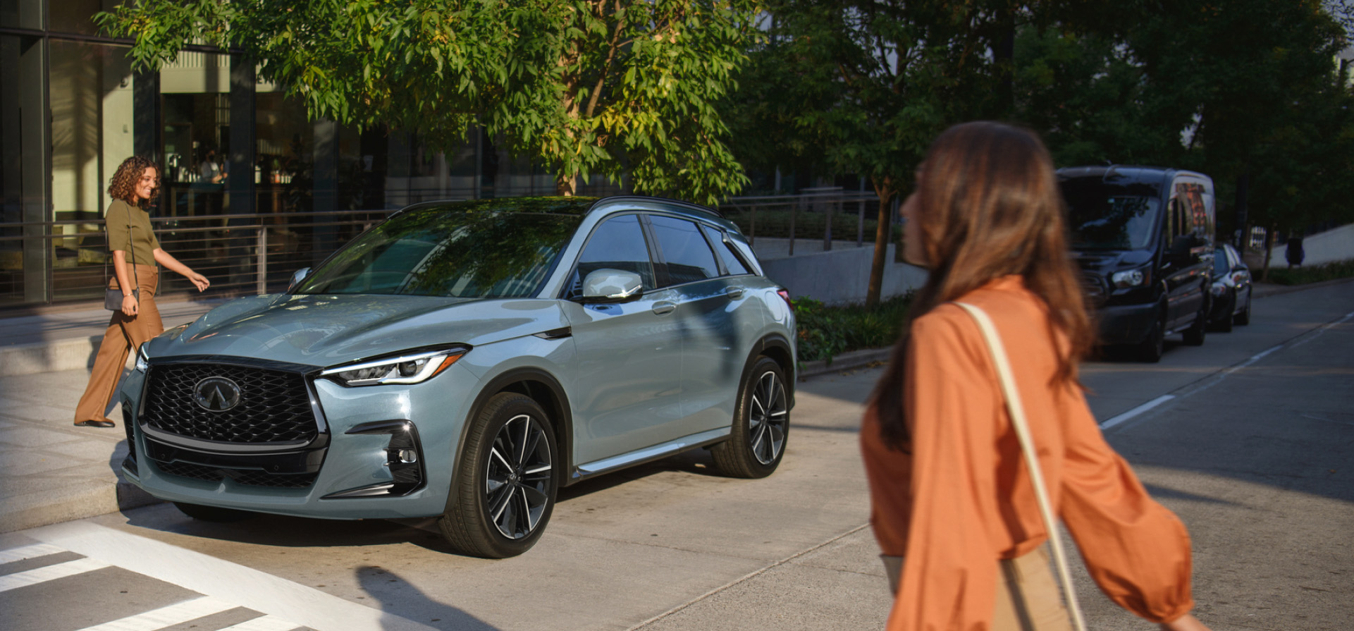 Owner walking towards INFINITI QX50