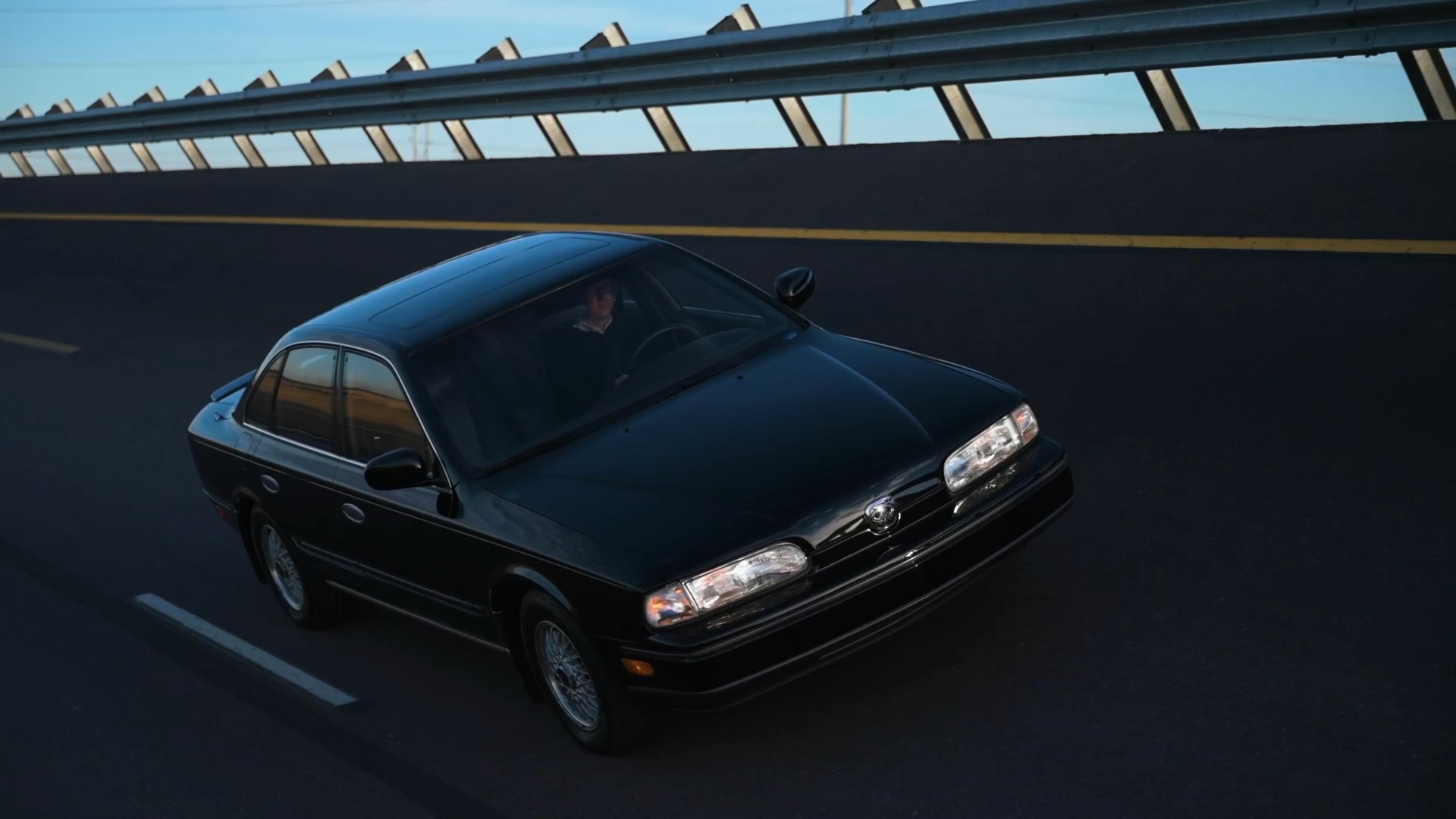 INFINITI Q45 Luxury Sedan driving across racetrack