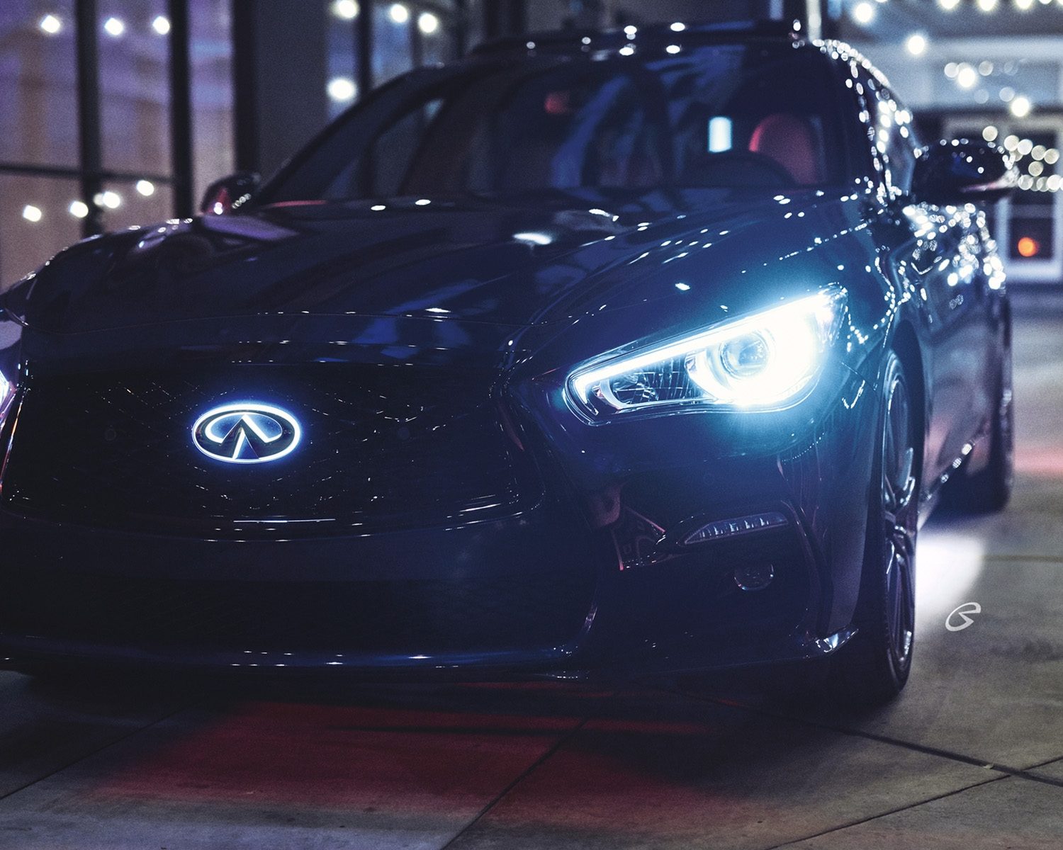 Front view of Q50 at night with lit LED badge