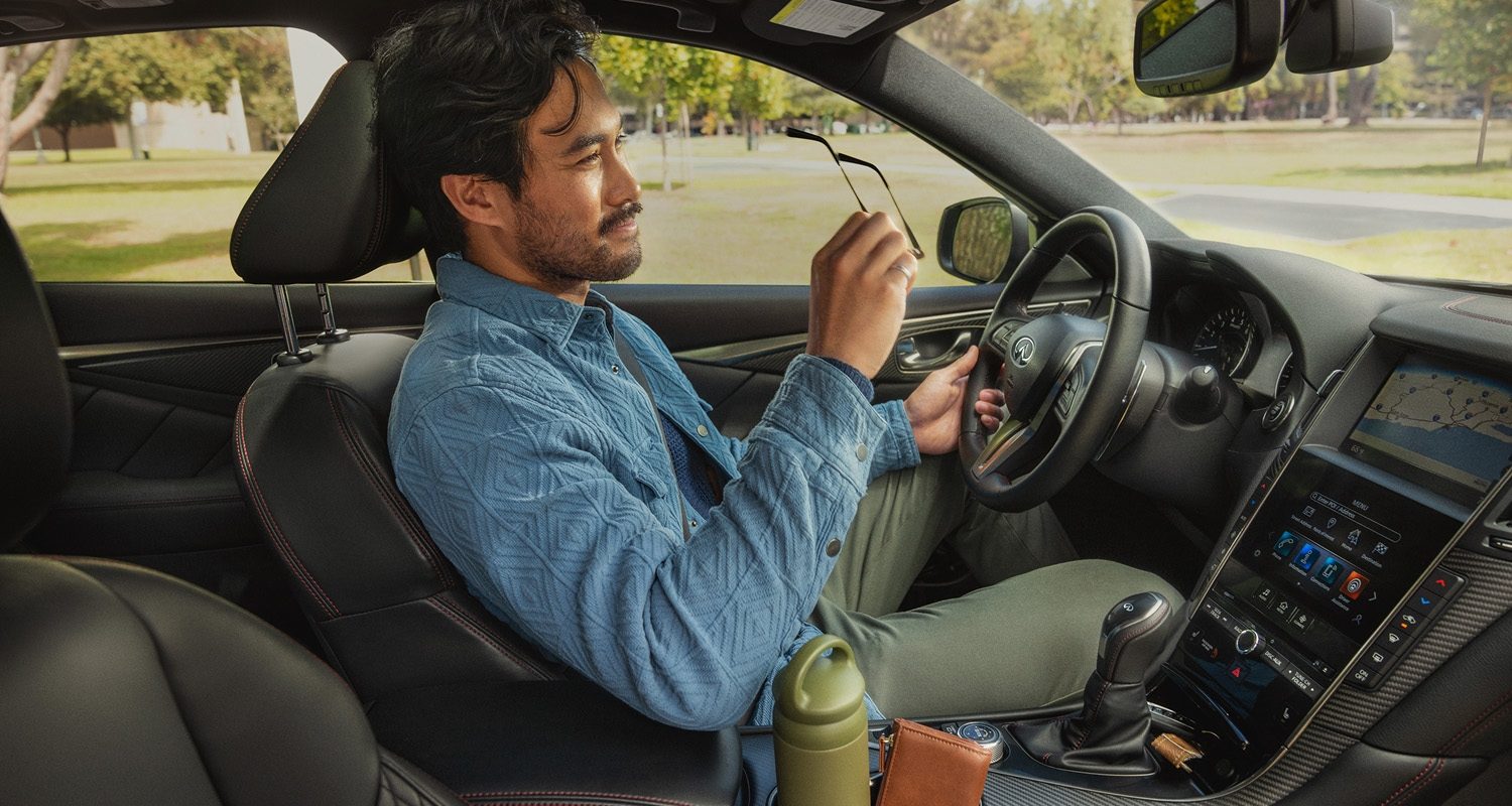 Man relaxing in Q50 with Zero Gravity seat