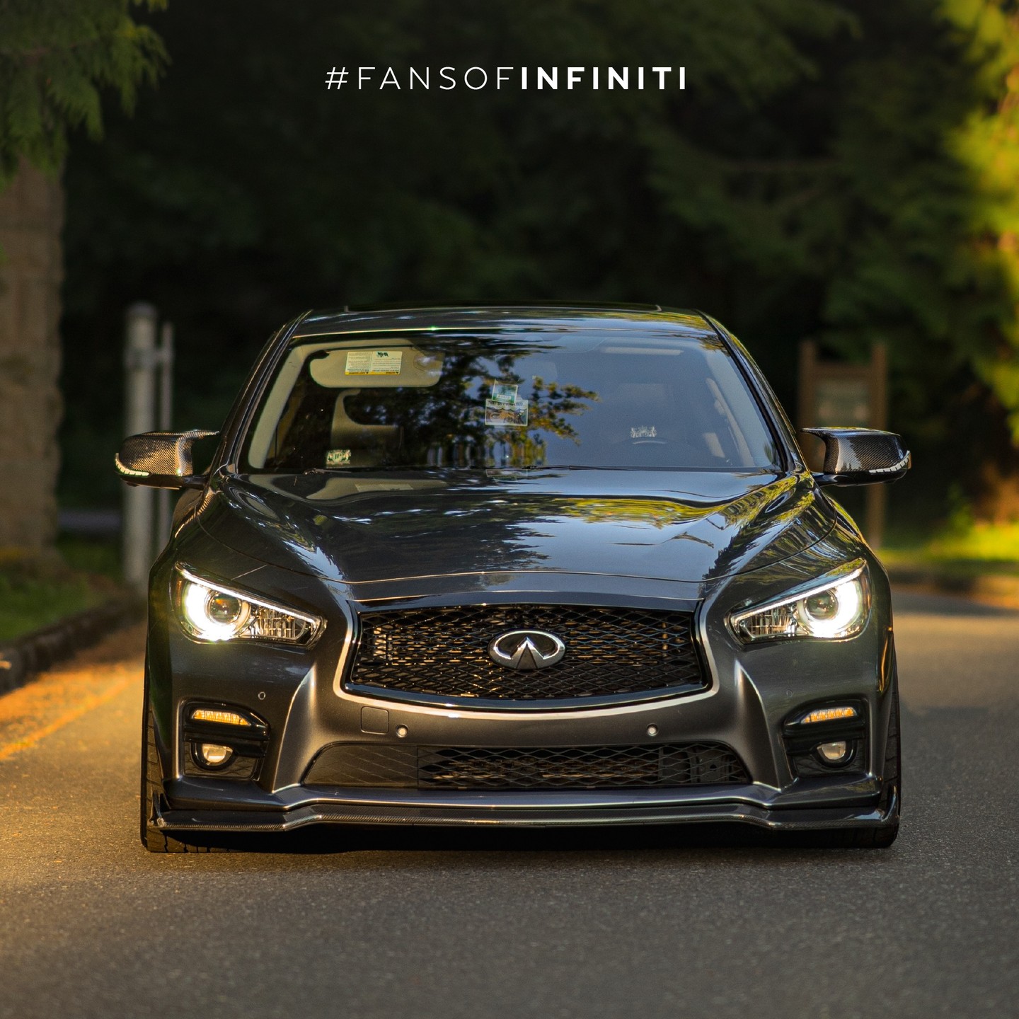 Black INFINITI Q50 parked outdoors at golden hour