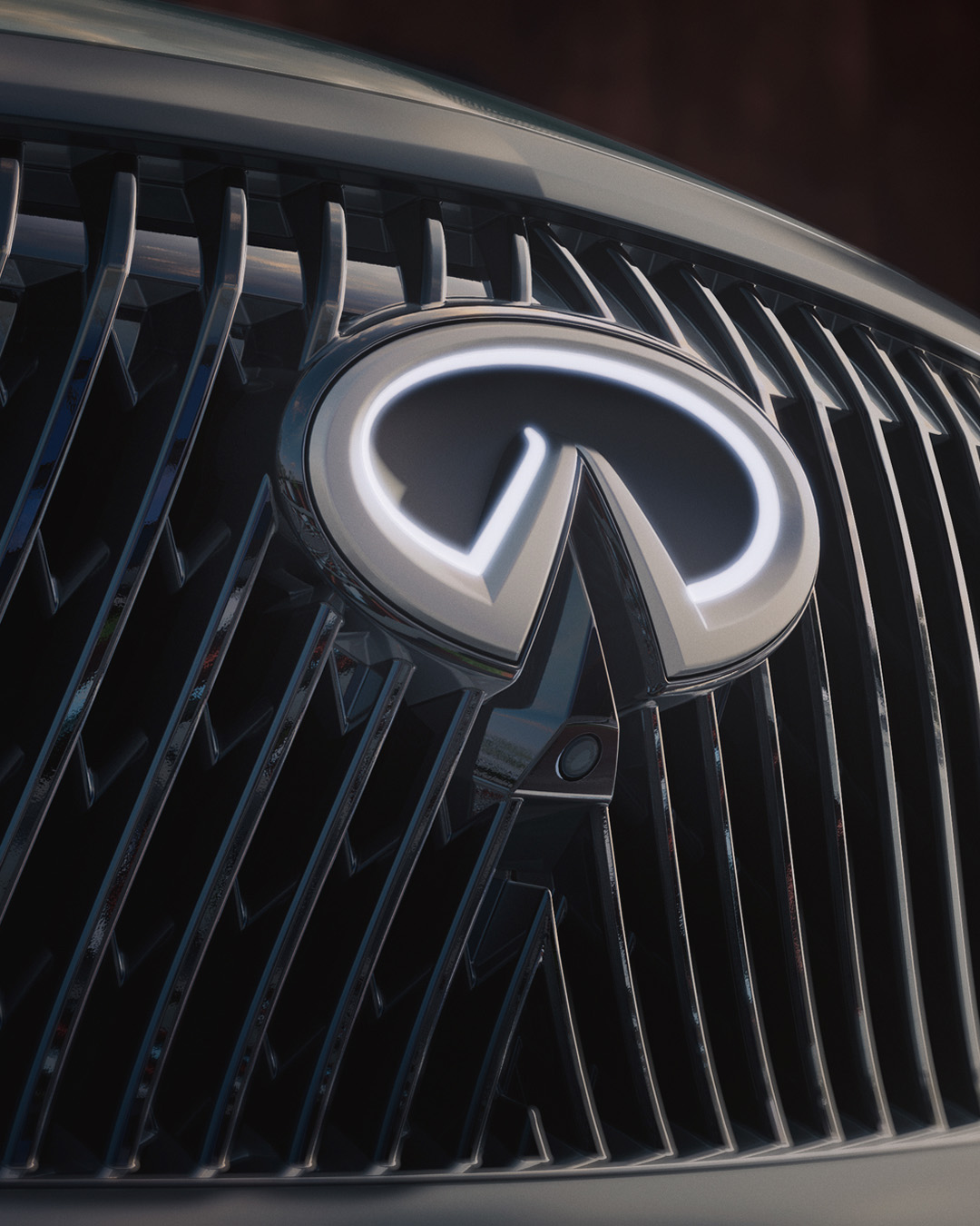 Close-up of INFINITI logo grille with lighting