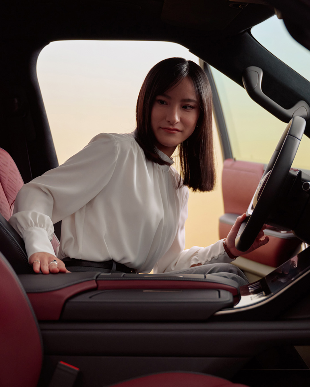 Woman smiling inside an INFINITI vehicle interior