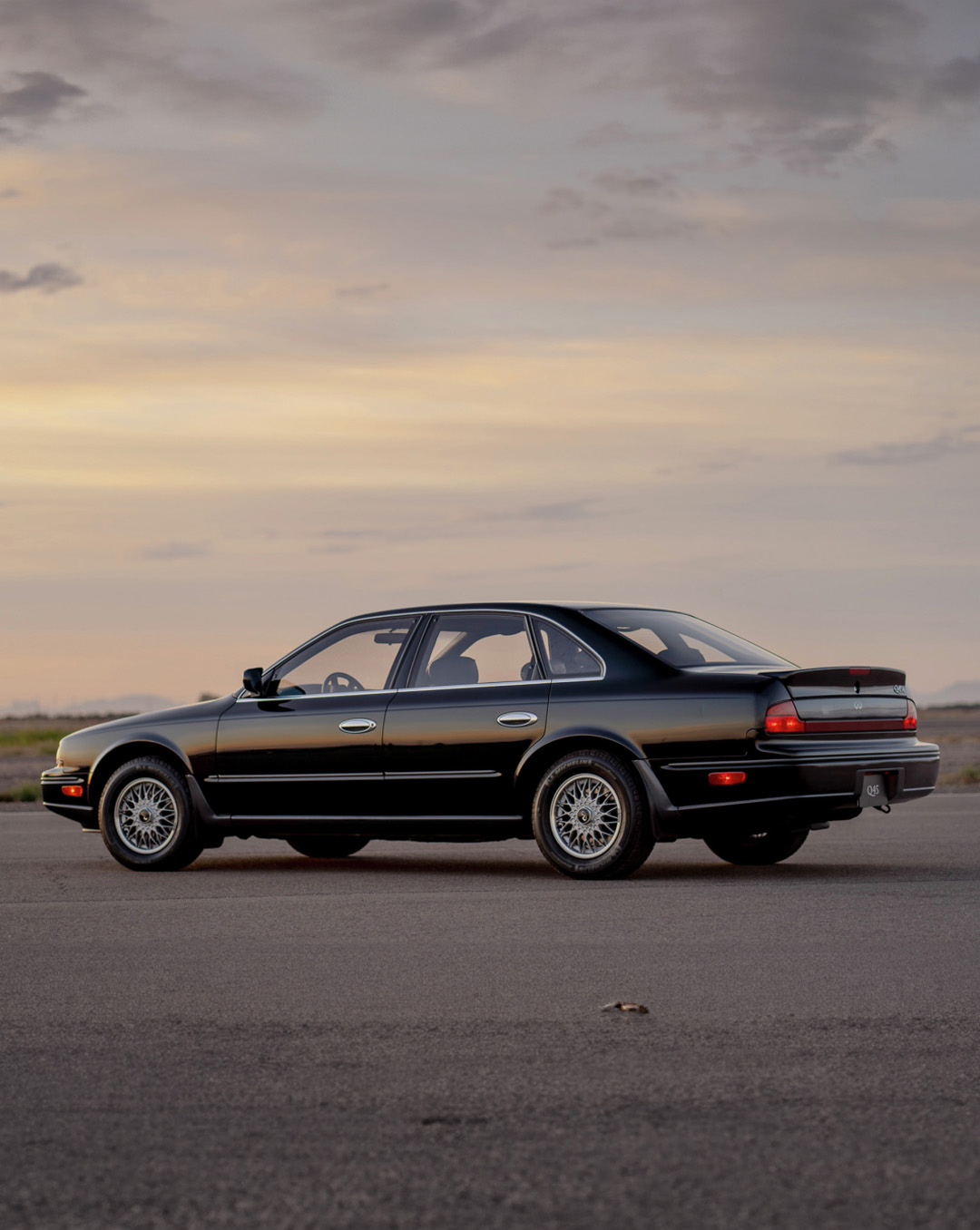 INFINITI Q45 in black parked on dirt landscape