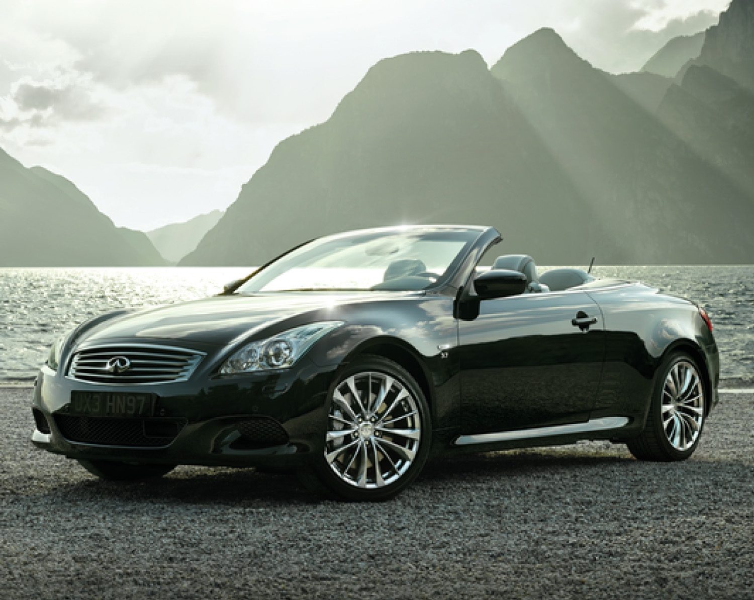 INFINITI Q60 Convertible parked in front of lake and mountains