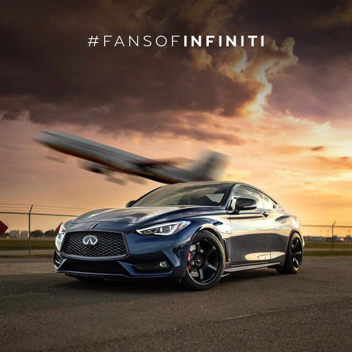 INFINITI Q60 parked in front of plane taking off