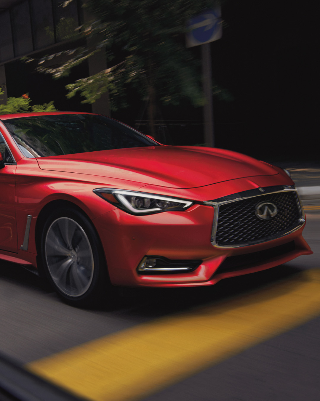 INFINITI Q60 driving through street demonstrating VC-turbo engine and horsepower