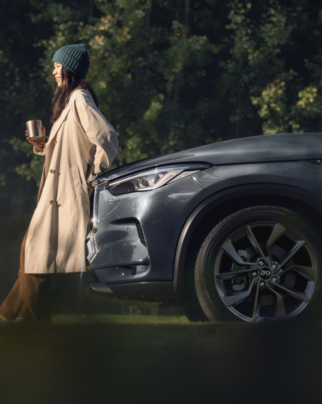 Owner leaning on INFINITI vehicle