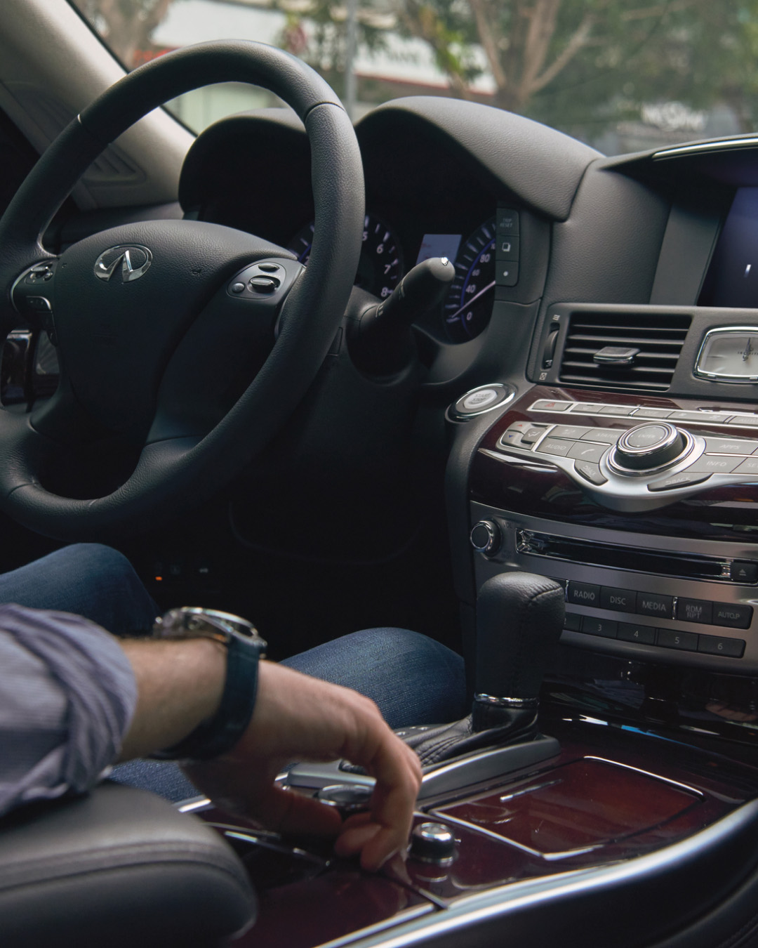 Interior view of INFINITI Q70 Luxury Sedan steering wheel and gear shift