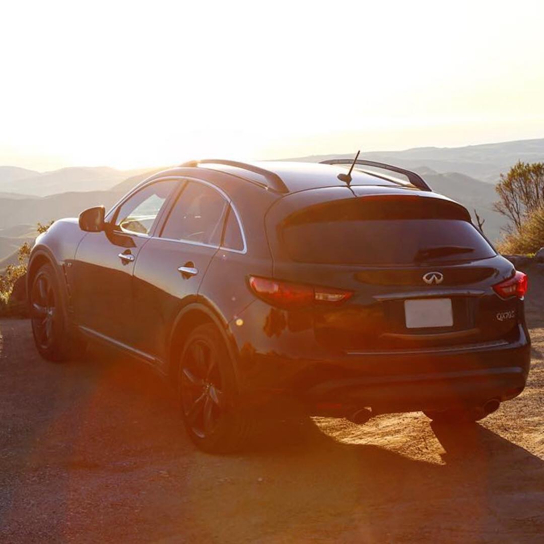 Rear view of INFINITI QX70 Luxury Crossover SUV parked on cliff