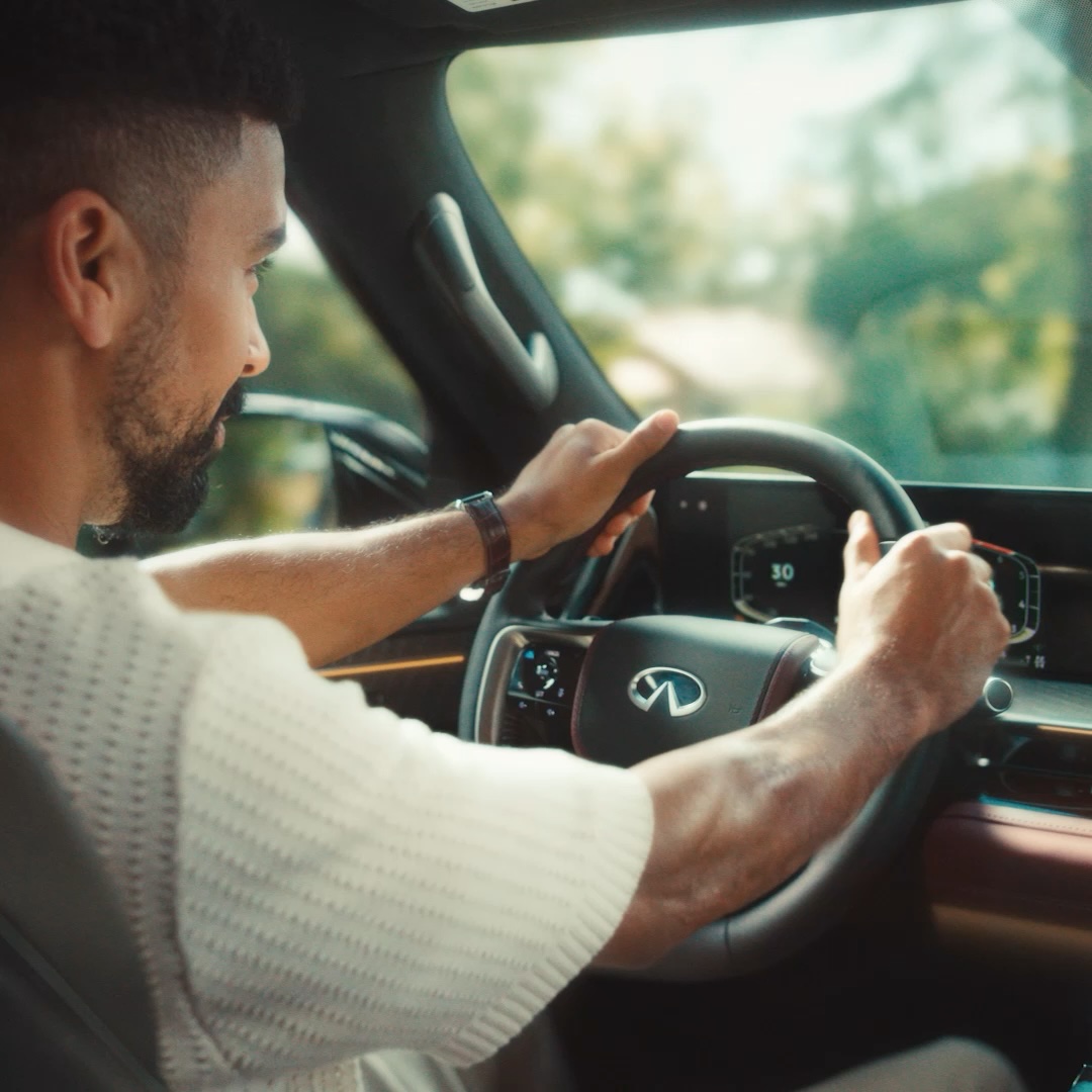 2026 INFINITI QX80 driver utilizing ProPILOT Assist safety technology for seamless assistance